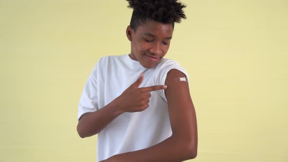 African American Teenager Showing COVID19 Vaccine Bandage Merrily alt