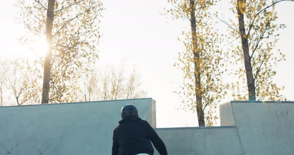 A Crazy Talented Daring Skater Spends Free Time on Ramp at Skatepark Drives Bmx Up alt