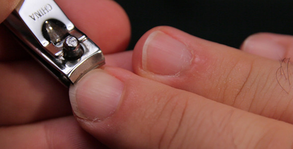 Man Cutting Fingernail