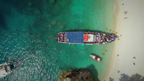 Aerial view of people disembarking off ferry, Ithaki island, Greece. alt