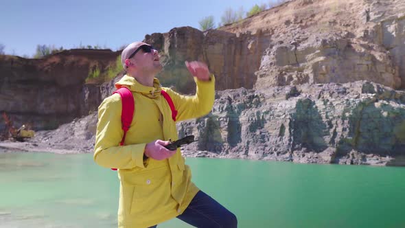 Drone Pilot Is Looking for a Quadcopter in the Sky. Young Man Controls a Drone Using a Remote