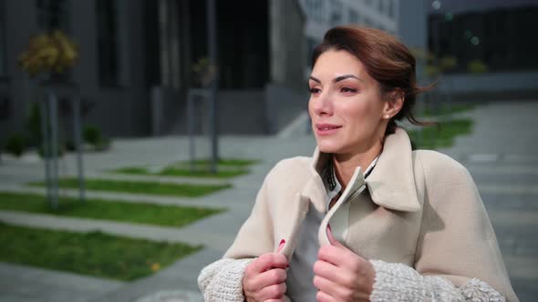 Attractive Woman Wrapped in a Outerwear Trying To Warm Up alt