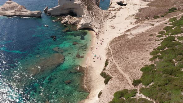 Aerial View of White Bluff Beach on Bay on the Coastline with Waves in the Blue Sea alt