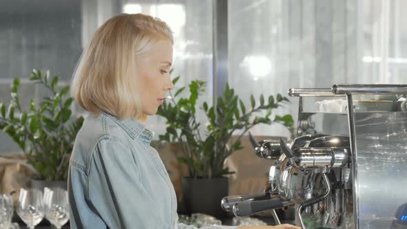 Charming Female Barista Smiling To the Camera After Preparing Coffee