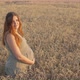Pregnant happy red-haired woman touching her belly, future young mother walking at sunset - VideoHive Item for Sale