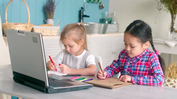 Multiethnic Little Girls Looking at Laptop and Drawing Pictures