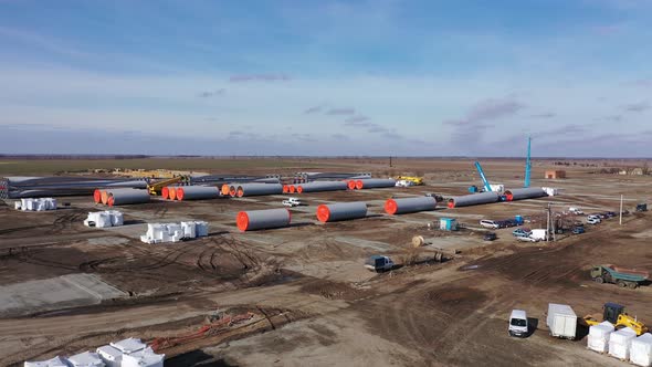 Amazing Aerial View on the Wind Turbine Parts on the Construction Site,  alt