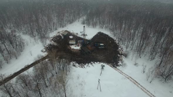 Drilling a Deep Well with a Drilling Rig in an Oil and Gas Field in Winter Forest. The Field Is