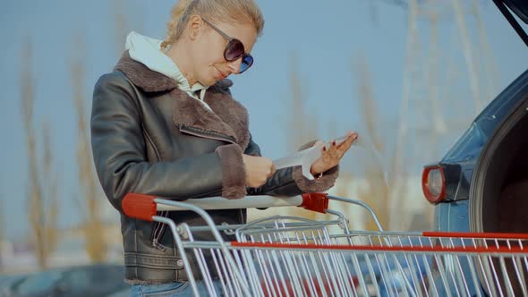 Home Finance Budget. Woman Check Bill Grocery Store Shopping Cart. Buyer Checks Paper Receipt. alt