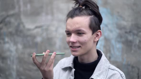 Teenage Boy Hold Smart Phone Sending Record Voice Message alt