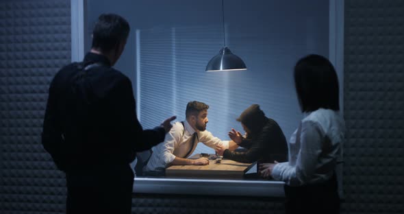 Investigators Watching an Interrogation alt