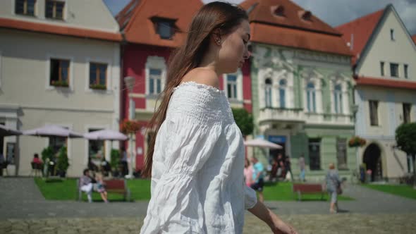 Townswoman of Small Slovakian Town Bardejov is Walking on Main Square alt