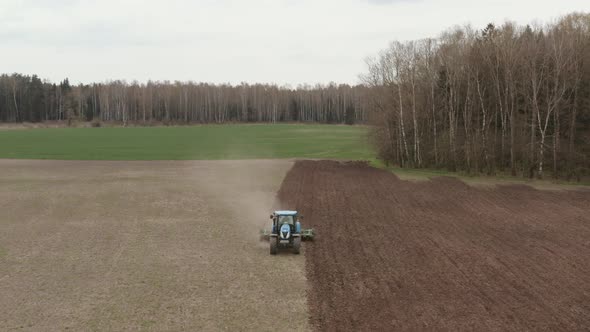 Tractor at Work in the Eco-Farming Field alt