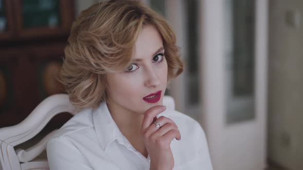 Portrait of Beautiful Blonde with Stylish Hairstyle and Red Lips Poses at Camera alt