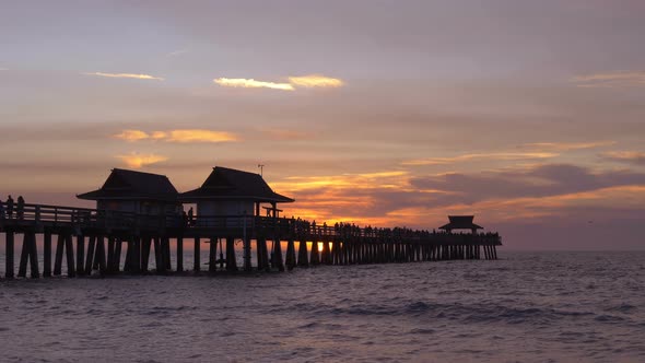 Dark Silhouette of a Pier Over the Water at Sunset