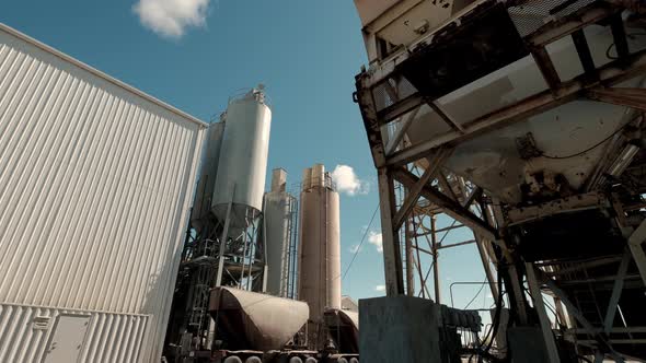 Cement Factory Buildings and Big Reservoirs with Materials Against Industrial Town at Hills Foot alt