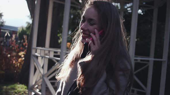 Woman Smiling On Phone Call In Park