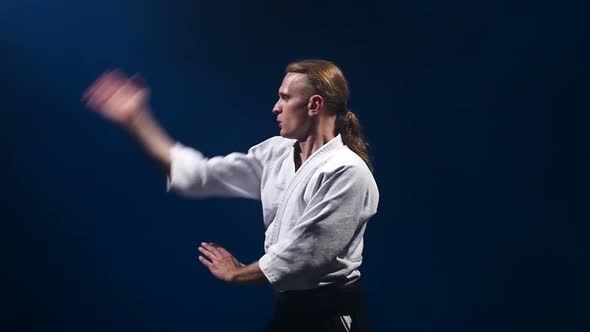 Master Participants of the Training in Special Clothes of Aikido Hakama Work Out the Methods of alt