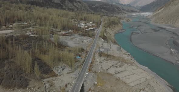 Aerial View Of Karakoram Highway Road Beside River At Hunza Valley. Circle Dolly alt