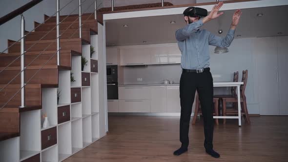 Serious Man Is Standing and Working Using New Virtual Reality Mask for Modern Lifestyle