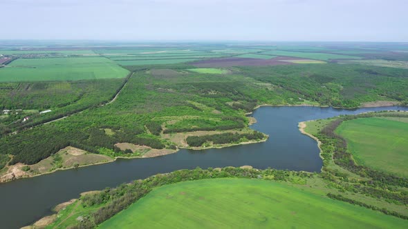 River, forest and agricultural fields from a bird's eye view.