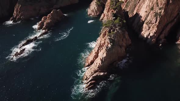 Flying above huge mediterranean cliffs on a sunny day