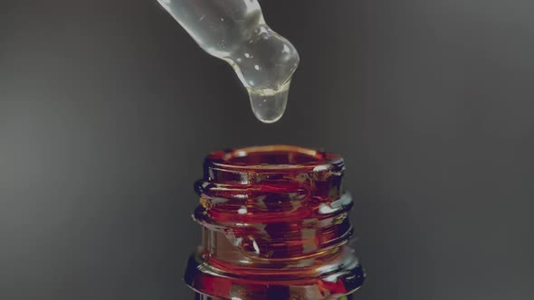 Pipette with a Drop of Face Serum or Oil for the Face and Hyaluronic Acid on Beautiful Black alt