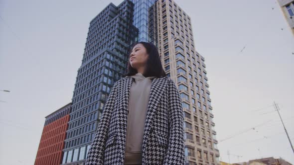 Lowangle Portrait of a Young Adult Asian Woman in Downtown District alt