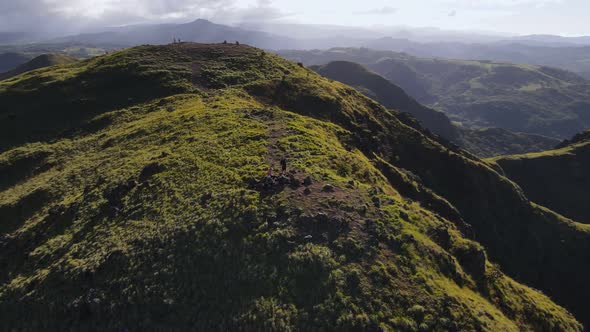 Aerial orbiting video of a group of people having breakfast on a mountain ridge in front of Pelado p alt