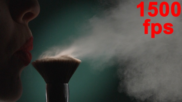 Female Lips Blowing On Make Up Brush With Powder Concept Of Beauty Green Aqua Menthe Background alt