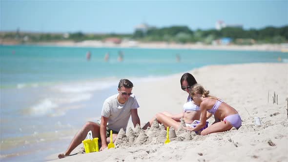 Father and Kids Making Sand Castle at Tropical Beach. Family Playing with Beach Toys