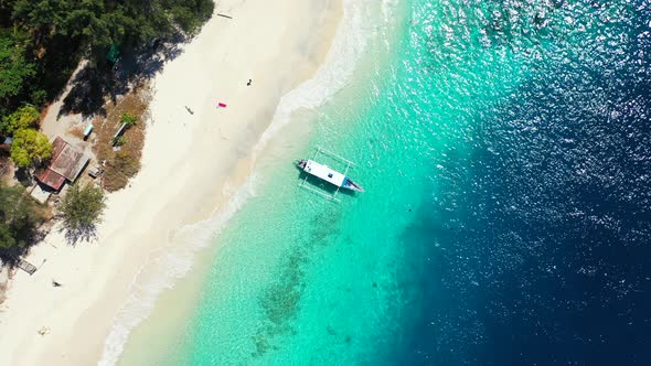Luxury overhead island view of a white sandy paradise beach and blue water background in colorful 4K alt