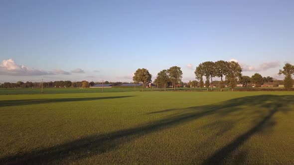 Aerial Cinematic Clip Drone Flying Over a Farm Field During Sunset alt