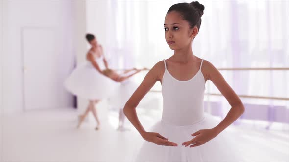 Girl Ballerina Stands in Ballet Pose
