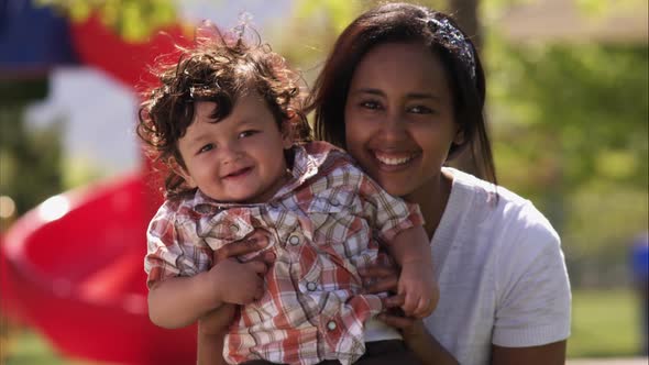 Slow handheld shot of Indian mother and child alt