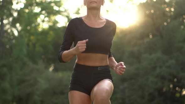 Young Sporty Woman Jumping on the Spot Outdoors, Slow Motion alt