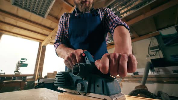 Slow Motion of a Wooden Block Getting Cut By the Carpenter alt