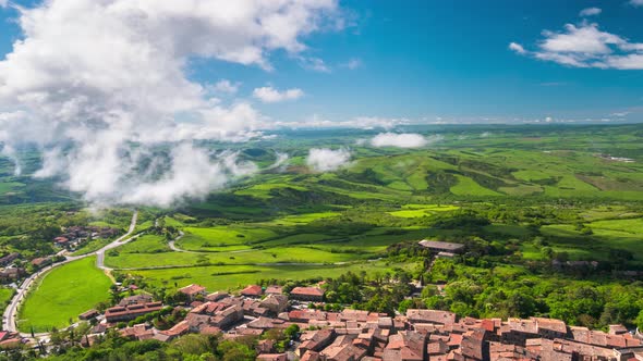 Time lapse aerial: unique green landscape in Orcia Valley, Tuscany, Italy. Scenic clouds moving by w alt