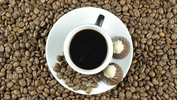 Rotating Black Coffee And Chocolate On Coffee Beans.