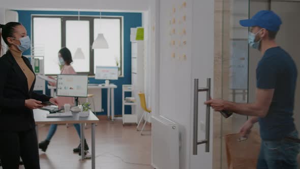 Businesswoman with Face Mask Against Coronavirus Paying Takeaway Food Order with Contactless Phone alt