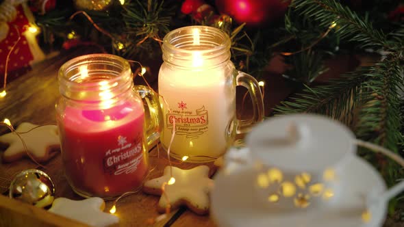 Two beautiful glass jars with candles burning inside