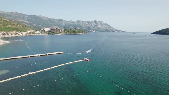 Aerial View of the Resort Sea Beach with Boats and Jet Skis in Budva Montenegro alt