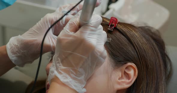 Woman undergo eyebrow microblading, permanent makeup
