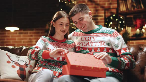 Christmas Gift Woman Opening Present With Surprise Sexy Underwear Laughing Enjoying Joke Boyfriend