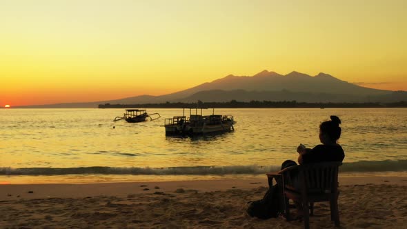 One woman tanning on marine bay beach voyage by blue water with clean sandy background of the Maldiv alt