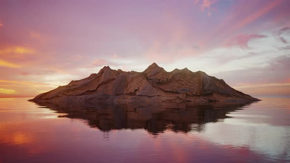 Rocky Island In Calm Water at Sunset Looping Background