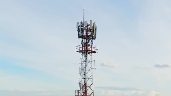Aerial View Shot By Drone Telecommunication Base Station With  Clouds And Blue Sky. alt