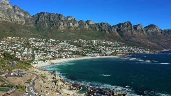 Wide angle aerial view of the entire bay around Camps Bay Cape Town