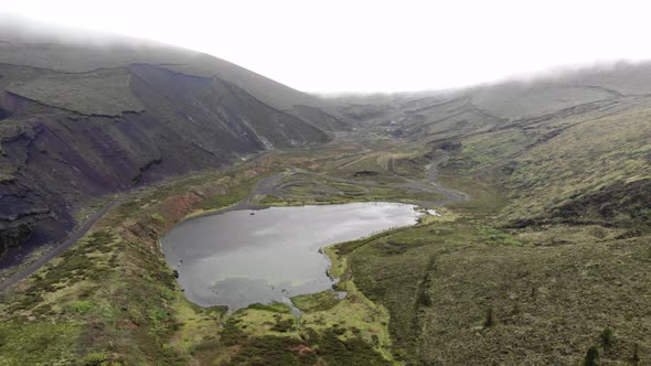 Lagoa do Peixe, one of the smallest lagoons in São Miguel Island, Azores - Aerial pull out fly-over alt