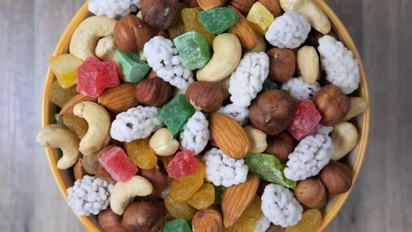 Sweets, raisin, candied fruit and nuts as a background, rotating. Close up view.